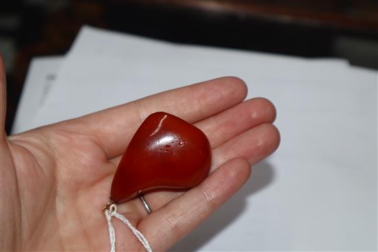 A yellow metal mounted natural amber pebble pendant, with GCS certificate dated 8/5/19.